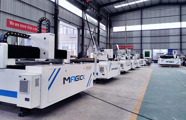 Row of fully assembled Magick laser cutting machines undergoing quality inspection on the factory floor.