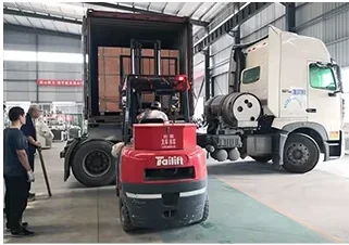 Forklift loading a compact 3015 fiber laser cutting machine into a 40HQ shipping container.