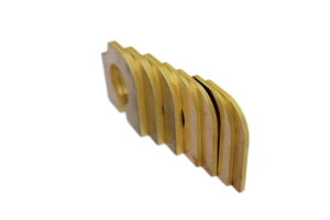 Laser-cut brass components with curved profiles and slots