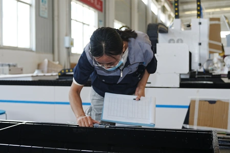 MAGICK technician inspecting machine assembly during quality control