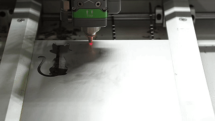 Laser cutting machine creating animal silhouette patterns in a metal sheet with the MK-DC